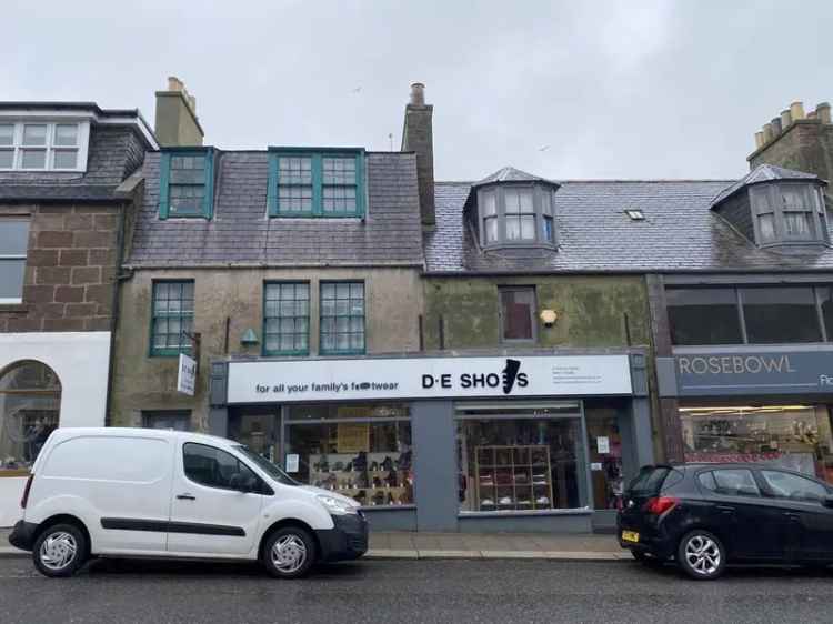 Mid-Terraced Stone Property with Dormer Projections and Rear Extension