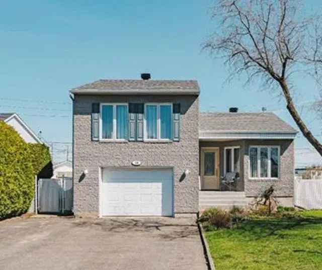 House for Sale: Charming Brick Home with Double Garage and Private Yard