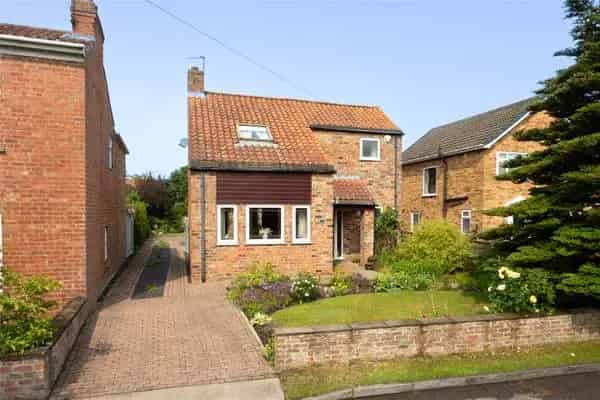 Charming Detached Village Residence with Double Garage and Landscaped Garden