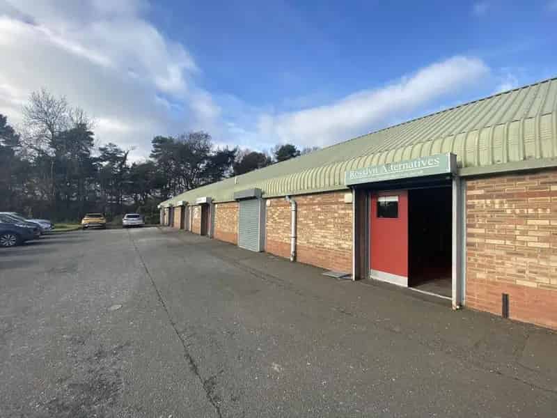 Industrial Unit For Lease: Brick Building with Roller Shutters and Parking