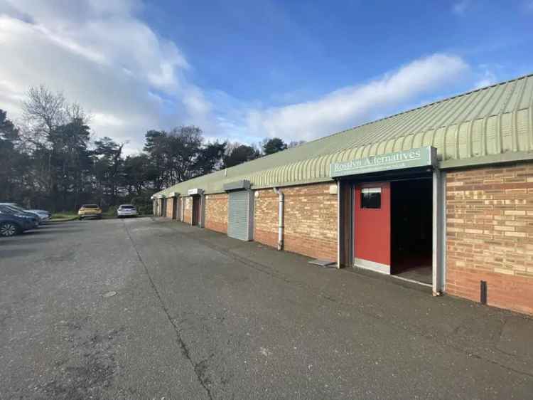 Industrial Unit For Lease: Brick Building with Roller Shutters and Parking