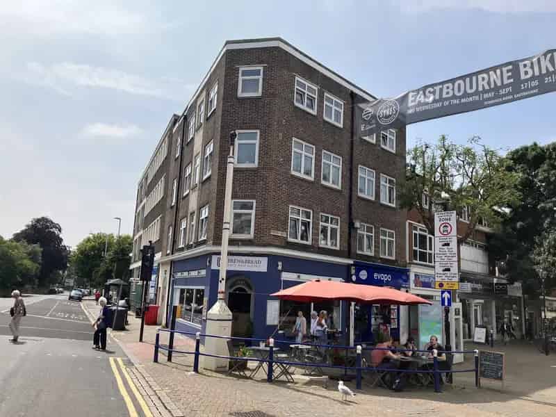 Four-Story Corner Building with Retail Units and Flats
