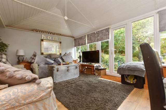 Immaculate Bungalow with Extensive Gardens and Stream Views Near Town Centre and Train Station